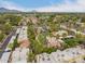 An aerial shot shows community features with the pool, lush palm trees, mature landscaping, and neighborhood views at 6542 N 7Th Ave # 30, Phoenix, AZ 85013