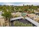 Aerial view highlighting the community's pool area and lush landscaping with palm trees at 6542 N 7Th Ave # 30, Phoenix, AZ 85013