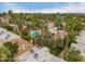 A picturesque aerial view showcases the community pool, surrounding landscaping, and mature trees at 6542 N 7Th Ave # 30, Phoenix, AZ 85013