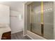 This updated bathroom features a tiled shower with glass doors, and modern fixtures at 6542 N 7Th Ave # 30, Phoenix, AZ 85013
