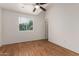 This bright bedroom features beautiful hardwood flooring and a ceiling fan at 6542 N 7Th Ave # 30, Phoenix, AZ 85013