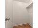 Walk-in closet showing built-in shelving and sleek wood flooring at 6542 N 7Th Ave # 30, Phoenix, AZ 85013