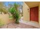 Cozy entryway with desert landscaping leading to the red front door at 6542 N 7Th Ave # 30, Phoenix, AZ 85013
