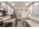 Modern kitchen features stainless steel appliances, gray cabinetry, and gray countertops at 6542 N 7Th Ave # 30, Phoenix, AZ 85013