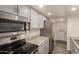 Modern kitchen features stainless steel appliances, gray cabinetry, and gray countertops at 6542 N 7Th Ave # 30, Phoenix, AZ 85013