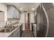 Modern kitchen features stainless steel appliances, gray cabinetry, and gray countertops at 6542 N 7Th Ave # 30, Phoenix, AZ 85013