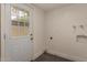 A well-lit laundry area with a backdoor and hookups for a washer and dryer at 6542 N 7Th Ave # 30, Phoenix, AZ 85013