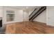 Open living area with hardwood floors, a fireplace, and staircase at 6542 N 7Th Ave # 30, Phoenix, AZ 85013