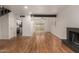 Large living area with hardwood floors, brick fireplace, and sliding glass doors to patio at 6542 N 7Th Ave # 30, Phoenix, AZ 85013
