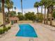 A well-maintained community pool with lounge chairs, tables and chairs and landscaping, providing a relaxing outdoor space at 6542 N 7Th Ave # 30, Phoenix, AZ 85013