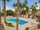 A view of the community pool, surrounded by palm trees, well-kept landscaping, and lounge chairs at 6542 N 7Th Ave # 30, Phoenix, AZ 85013