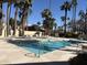 Inviting community pool surrounded by lounge chairs and swaying palm trees, perfect for relaxing on sunny days at 6542 N 7Th Ave # 30, Phoenix, AZ 85013