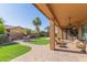 This backyard is the perfect spot for entertaining, featuring a seating area and green lawn at 6881 W Greenbriar Dr, Glendale, AZ 85308