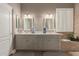 A bathroom features a double sink vanity, shaker cabinets, neutral walls, and ceramic tile floors at 6881 W Greenbriar Dr, Glendale, AZ 85308