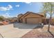 Exterior view of a home with an extended driveway leading to a three-car garage at 6881 W Greenbriar Dr, Glendale, AZ 85308