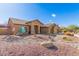 Inviting single-story home with desert landscaping including a stone water feature in the front yard at 6881 W Greenbriar Dr, Glendale, AZ 85308