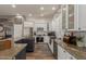 Close up on a kitchen with white cabinets, a stainless steel stove, and granite countertops at 6881 W Greenbriar Dr, Glendale, AZ 85308