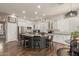 Bright kitchen featuring white cabinets, granite countertops, an island, and modern appliances at 6881 W Greenbriar Dr, Glendale, AZ 85308