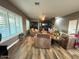 A cozy living room with lots of seating, natural light, a ceiling fan, and modern flooring at 6881 W Greenbriar Dr, Glendale, AZ 85308