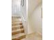 Bright stairway featuring tile steps, a white handrail, and natural light from a shuttered window at 710 S Beck Ave, Tempe, AZ 85281