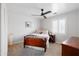 Bright bedroom with a ceiling fan, neutral carpet, and a dark wood bed at 710 S Beck Ave, Tempe, AZ 85281