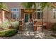 Charming front entrance with brick accents, concrete steps and a vibrant teal-colored door at 710 S Beck Ave, Tempe, AZ 85281