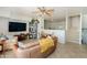 Bright living room with a ceiling fan, large TV, and comfortable leather sofa with natural light at 710 S Beck Ave, Tempe, AZ 85281