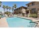 Community pool area surrounded by townhouses, palm trees, lounge chairs, and a secure fence at 710 S Beck Ave, Tempe, AZ 85281