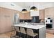 This kitchen features wooden cabinets, a stainless steel refrigerator, and a center island with black countertops at 9246 N 108Th St, Scottsdale, AZ 85259