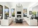 Living room featuring a modern fireplace, four chairs, and a neutral color palette at 9246 N 108Th St, Scottsdale, AZ 85259