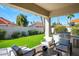 Inviting covered patio with outdoor seating, a built-in grill, and lush landscaping at 9246 N 108Th St, Scottsdale, AZ 85259