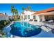 Gorgeous backyard pool with a white tile deck, palm trees, and a view of the house at 9246 N 108Th St, Scottsdale, AZ 85259