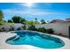 Inviting backyard pool with lush landscaping, palm trees, and privacy fencing at 9246 N 108Th St, Scottsdale, AZ 85259