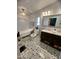 Stylish bathroom with modern bathtub, vanity, and decorative tile flooring at 9302 E Broadway Rd # 64, Mesa, AZ 85208