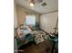 Cozy bedroom with dinosaur decor, a colorful bed, and a patterned rug at 9302 E Broadway Rd # 64, Mesa, AZ 85208