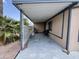 Attached carport featuring ample space, chairs, a bench and desert landscaping at 9302 E Broadway Rd # 64, Mesa, AZ 85208