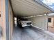 Attached carport view featuring ample parking space and a modern car at 9302 E Broadway Rd # 64, Mesa, AZ 85208