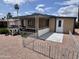 Single-story home featuring covered porch, desert landscaping, and ample outdoor space at 9302 E Broadway Rd # 64, Mesa, AZ 85208
