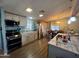 Modern kitchen with stainless steel appliances, ample counter space and an adjacent dining area at 9302 E Broadway Rd # 64, Mesa, AZ 85208