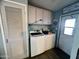 Functional laundry room with washer, dryer, and ample cabinet space at 9302 E Broadway Rd # 64, Mesa, AZ 85208