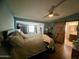 Spacious main bedroom with wood floors, ceiling fan, and convenient en suite bathroom at 9302 E Broadway Rd # 64, Mesa, AZ 85208