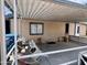 Covered patio with seating area; part of a single story home at 9302 E Broadway Rd # 64, Mesa, AZ 85208