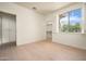 Bedroom features wood floors, window with shutters, and closet at 9550 E Thunderbird Rd # 259, Scottsdale, AZ 85260