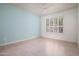 Bright bedroom with blue accent wall, shuttered windows, and wood flooring at 9550 E Thunderbird Rd # 259, Scottsdale, AZ 85260