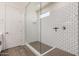 Modern bathroom featuring a glass-enclosed shower with white subway tile and a minimalist design at 1075 S Tumbleweed Ln, Chandler, AZ 85286