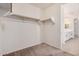 Walk-in closet with ample shelving space leading into an ensuite bathroom at 1075 S Tumbleweed Ln, Chandler, AZ 85286