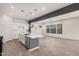 Open-concept kitchen with white cabinets, a gray island, stainless steel appliances, and an adjacent living area at 1075 S Tumbleweed Ln, Chandler, AZ 85286