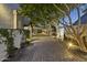 Charming backyard with stone walkway, lush landscaping, and string lights creating a relaxing ambiance at 12593 E Desert Cove Ave, Scottsdale, AZ 85259