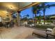 Charming backyard with a shaded patio, a waterfall feature, and lush, green landscaping at 12593 E Desert Cove Ave, Scottsdale, AZ 85259