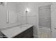 Bright bathroom features a marble countertop and a door leading to a tiled shower at 12593 E Desert Cove Ave, Scottsdale, AZ 85259
